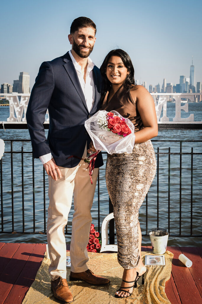 Newly engaged couple portrait with Manhattan skyline at Chart House by Alex Kaplan Photography