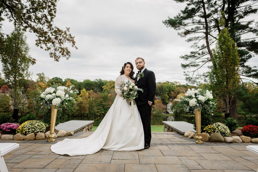 Bride and groom portrait at ceremony site with fall foliage Ramsey Country Club by Alex Kaplan Photography