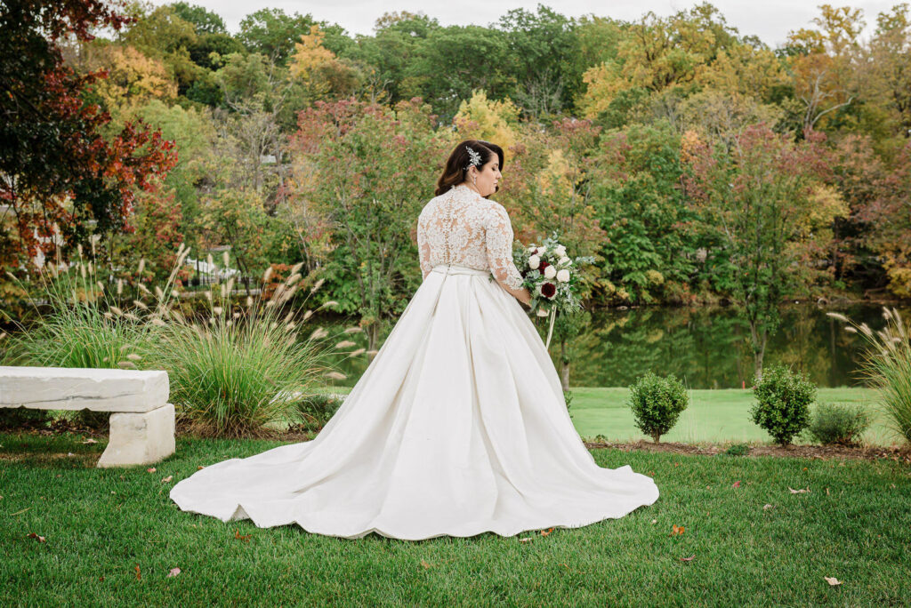 Romantic kiss with fall colors backdrop at Ramsey Country Club wedding photographed by Alex Kaplan Photography