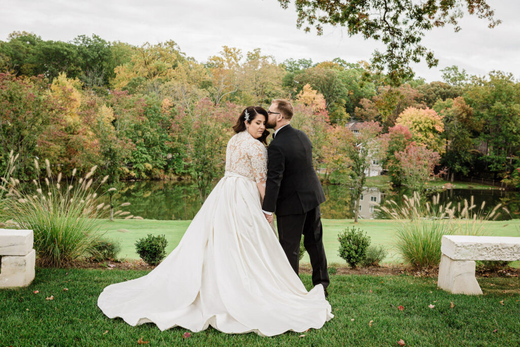 Romantic couple portrait by lake with autumn foliage Ramsey Country Club photographed by Alex Kaplan Photography