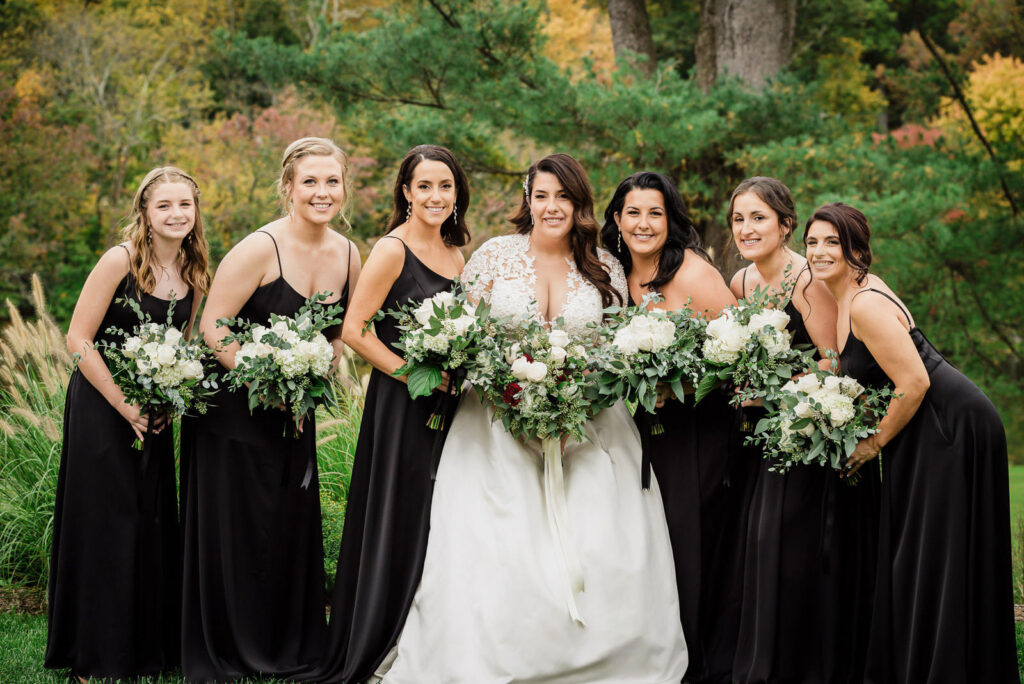 Bridesmaids in black gowns with white bouquets at Ramsey Country Club wedding by Alex Kaplan Photography