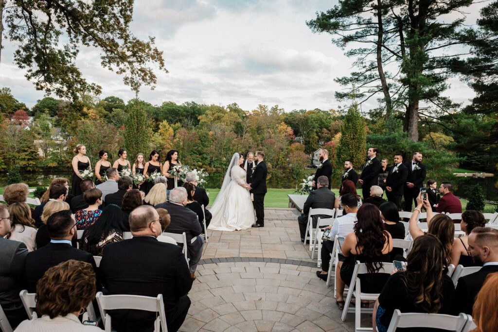 Complete ceremony view with guests and fall backdrop Ramsey Country Club wedding Alex Kaplan Photography