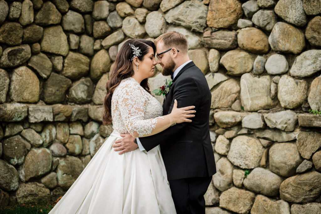 Intimate couple moment by fieldstone wall Ramsey Country Club fall wedding by Alex Kaplan