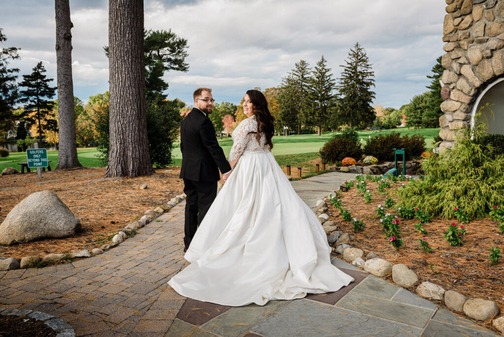 Newlyweds on paver walkway overlooking golf course Ramsey Country Club by Alex Kaplan