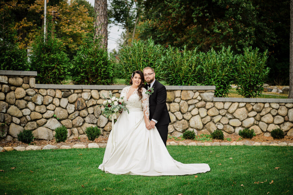 Elegant couple portrait with historic fieldstone wall Ramsey Country Club by Alex Kaplan