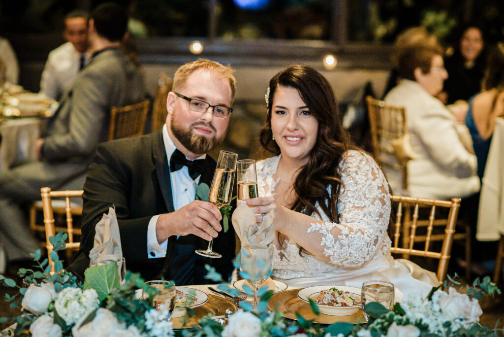 Bride and groom toasting with champagne at head table Ramsey Country Club Alex Kaplan
