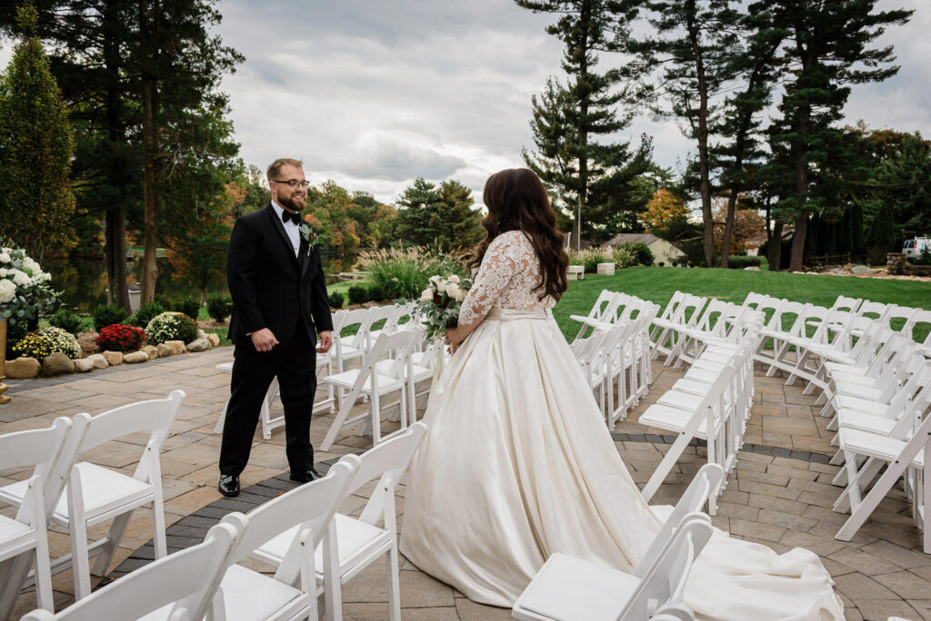 Bride and groom first look moment at Ramsey Country Club fall wedding photographed by Alex Kaplan