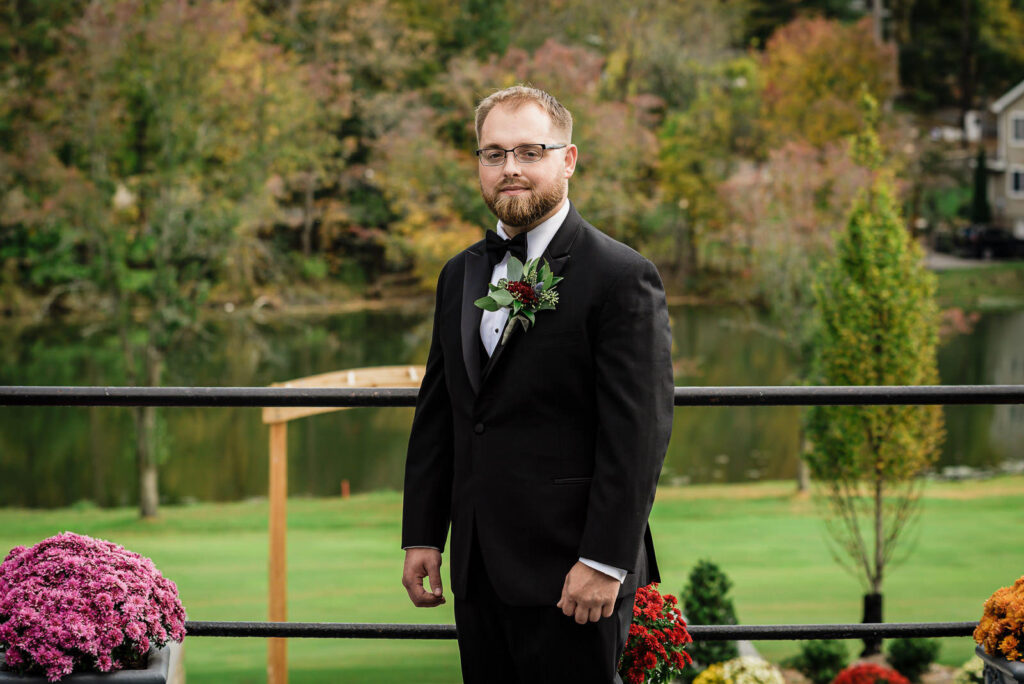 Groom portrait with fall foliage backdrop at Ramsey Country Club wedding by Alex Kaplan Photography