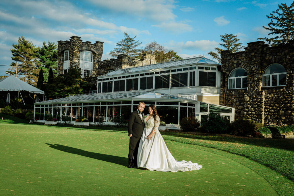 Couple on putting green with Lakeside Grille building behind at Ramsey Country Club Alex Kaplan Photography