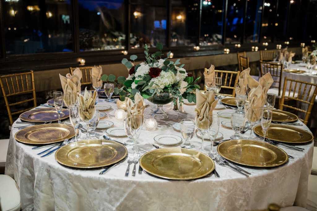 Reception centerpiece with white hydrangeas burgundy dahlias eucalyptus Ramsey Country Club Alex Kaplan