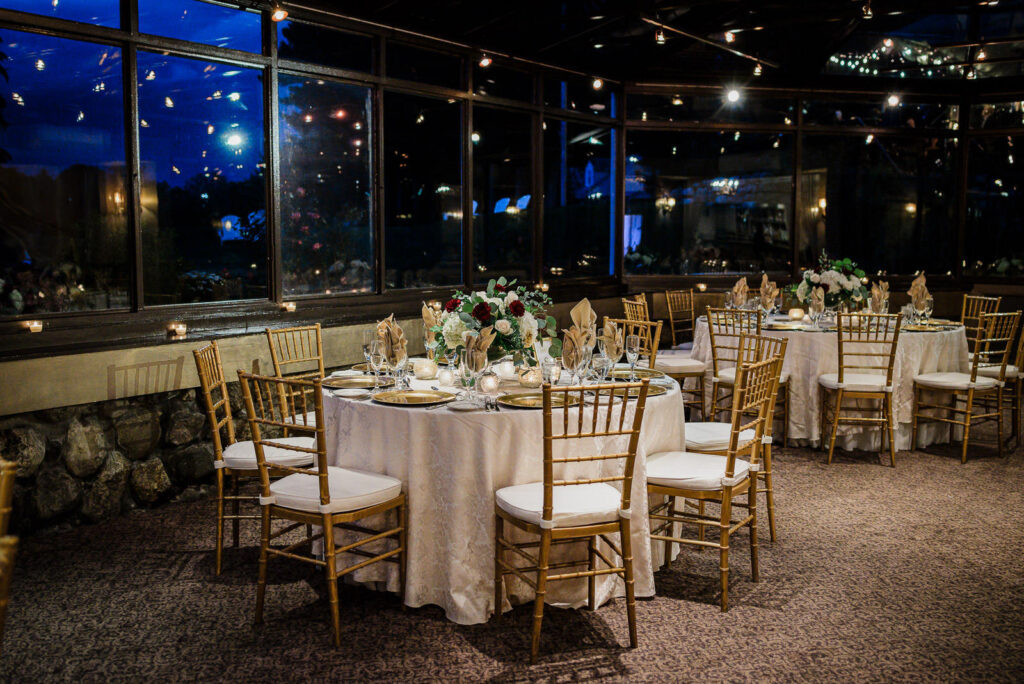 Lower reception level with elegant table settings and staircase Ramsey Country Club Alex Kaplan
