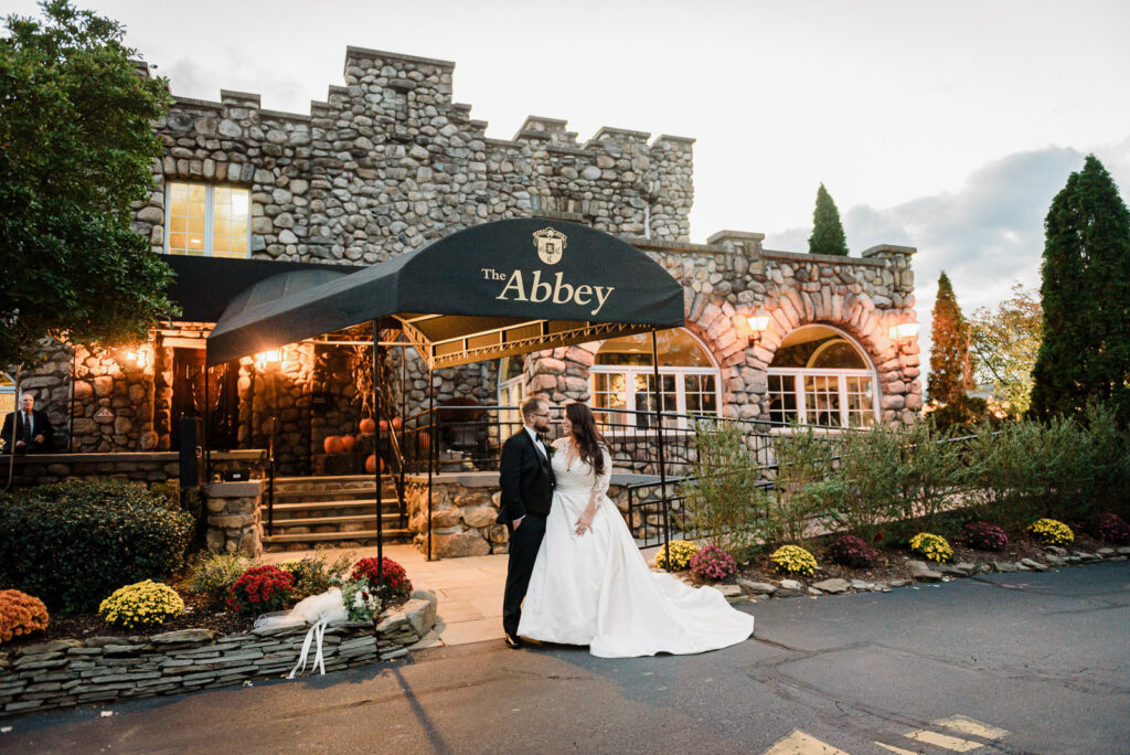 Elegant reception table with gold chargers and white floral centerpiece Ramsey Country Club by Alex Kaplan Photography