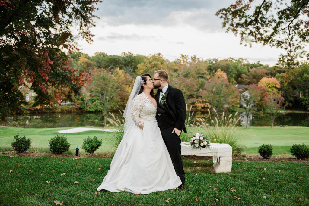 Romantic post-ceremony kiss with fall colors Ramsey Country Club wedding Alex Kaplan Photography