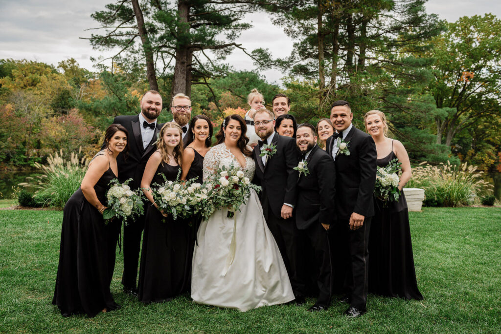Bridal party group portrait with pine trees at Ramsey Country Club photographed by Alex Kaplan
