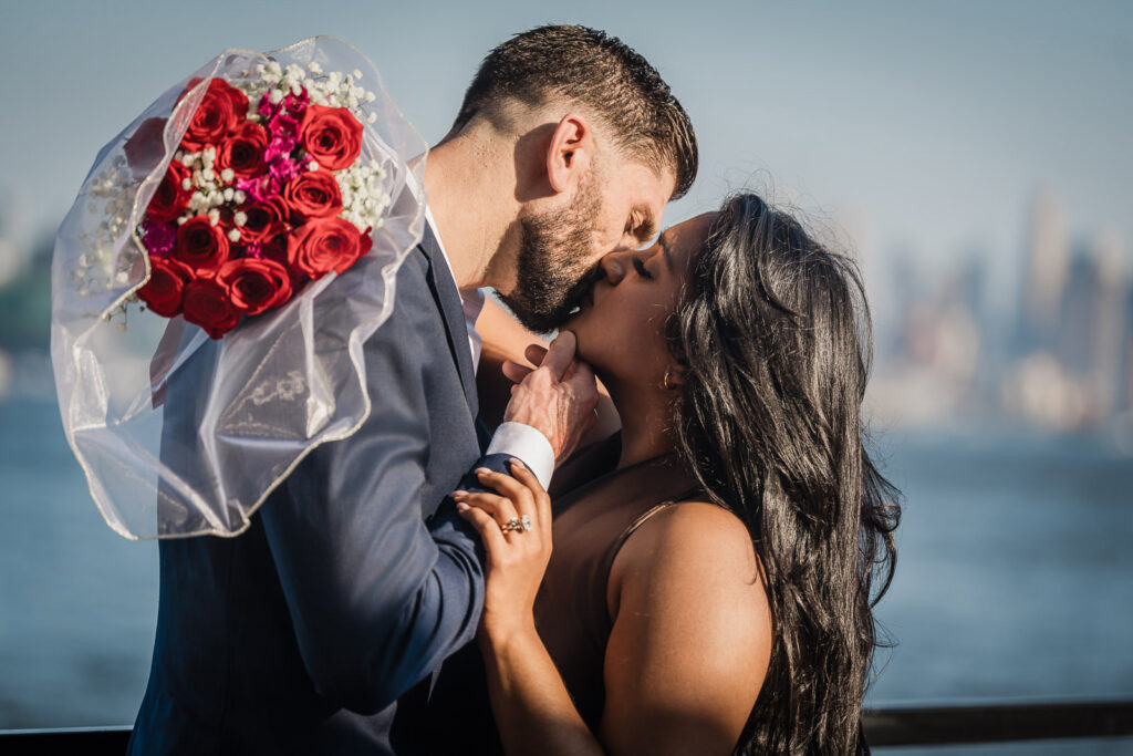 Romantic couple kiss during Chart House engagement session by Alex Kaplan Photography