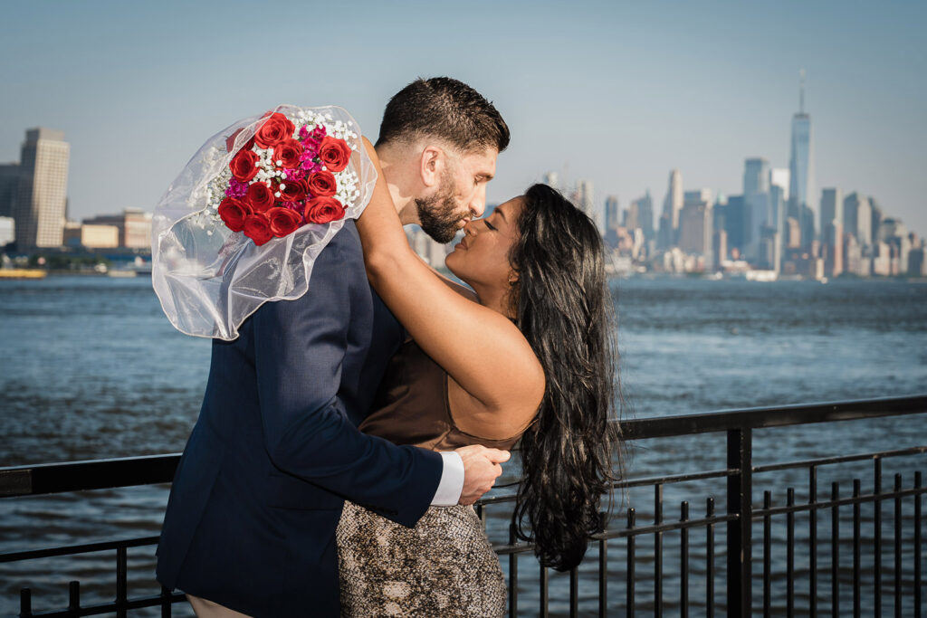 Romantic engagement photo with Manhattan skyline backdrop by Alex Kaplan Photography