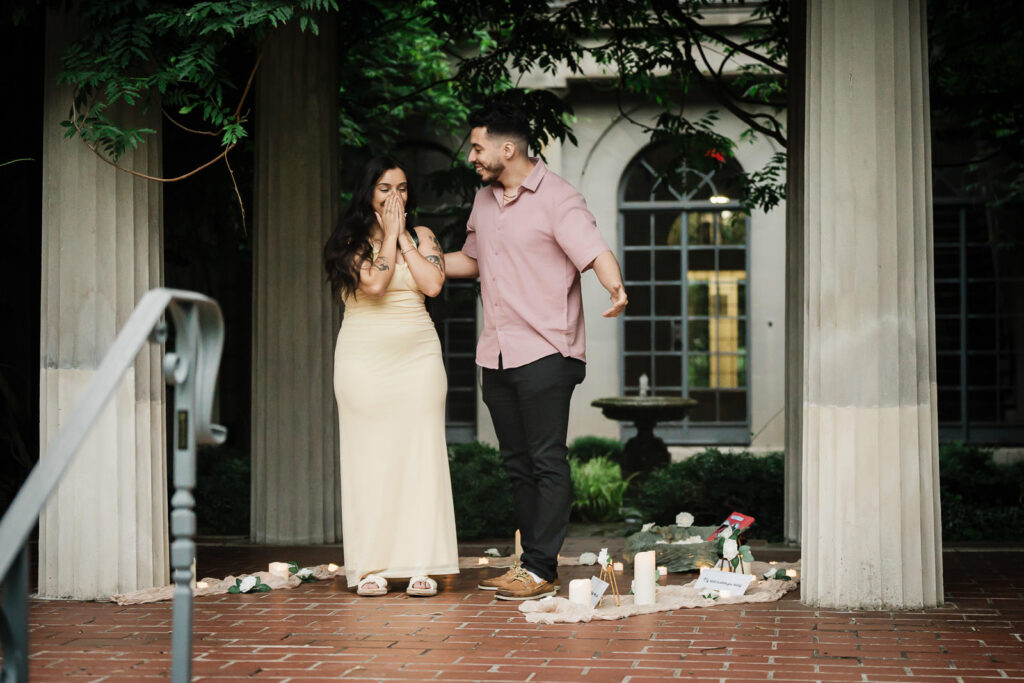 New Jersey proposal photographer Alex Kaplan captures bride's emotional reaction to surprise garden proposal with candles