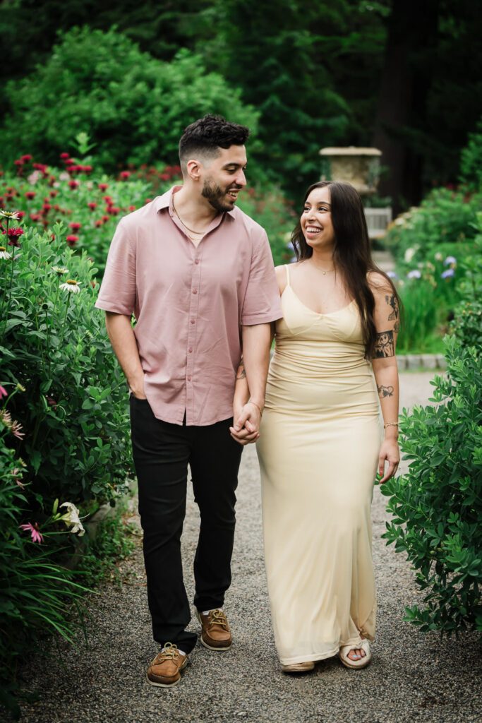 Montclair NJ engagement photographer Alex Kaplan captures newly engaged couple walking hand in hand through Van Vleck House & Garden