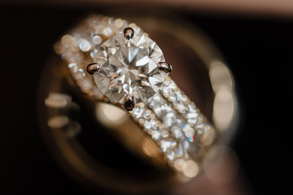 Close-up macro photography of diamond engagement ring with wedding bands detail shot by Alex Kaplan Photography