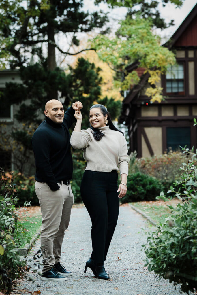 Excited newly engaged bride shows off engagement ring in celebration at Van Vleck Gardens pathway, Northern New Jersey proposal photographer Alex Kaplan