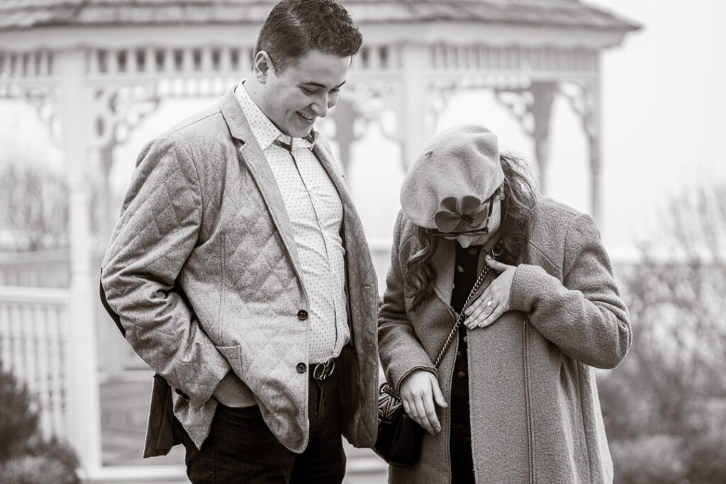 Black-and-white candid of engaged couple walking through Japanese-inspired gardens at Mount Fuji.