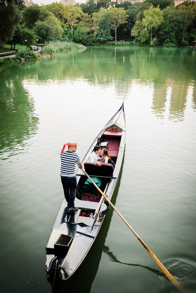 name: central-park-gondola-loeb-boathouse-scenic-view.jpg
Alt Text: Scenic view of Venetian gondola with couple and gondolier on Central Park lake near Loeb Boathouse restaurant