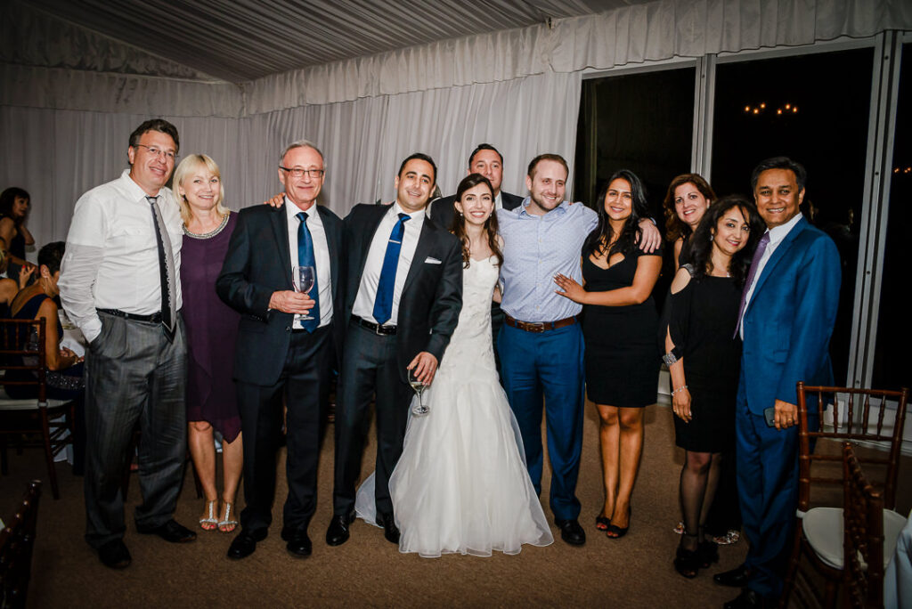 Bride and groom with close friends group in formal attire at Hamilton Farm evening reception