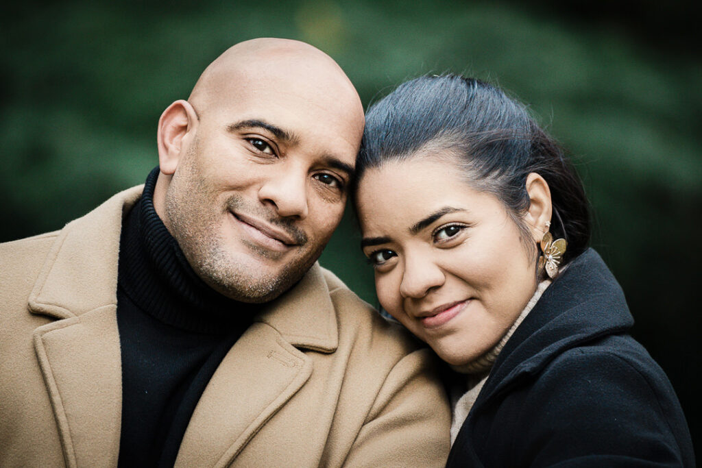 Intimate close-up portrait of newly engaged couple at Van Vleck Gardens with fall foliage background, professional engagement photography Montclair NJ