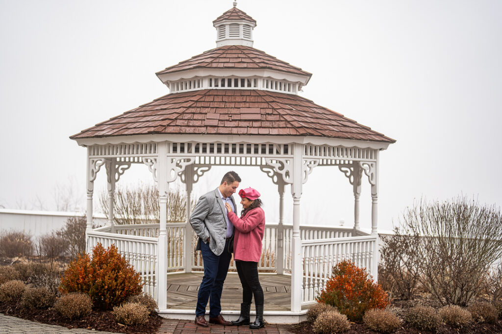 Couple embraces after proposal at gazebo, soft winter light at Mount Fuji, Hudson Valley.
