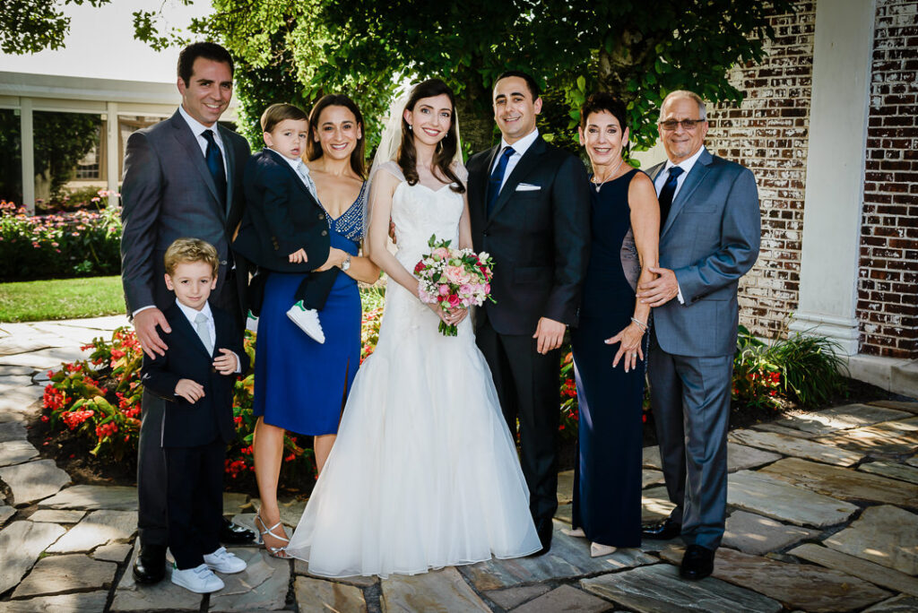 Multi-generational Jewish family portrait with bride, groom, siblings, and young ring bearers at Hamilton Farm