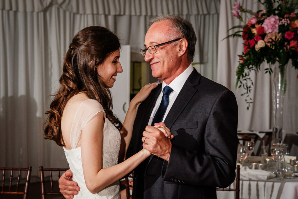 Intimate closeup of bride smiling at father during emotional father-daughter dance at Hamilton Farm