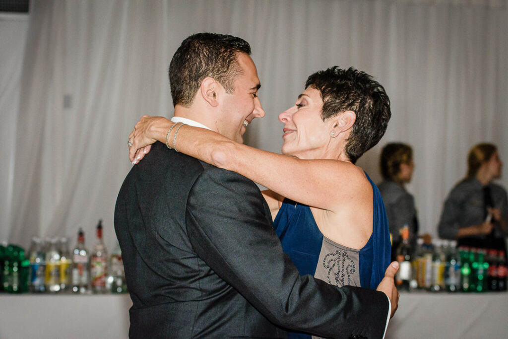 Groom sharing emotional dance with mother in royal blue dress at Hamilton Farm reception