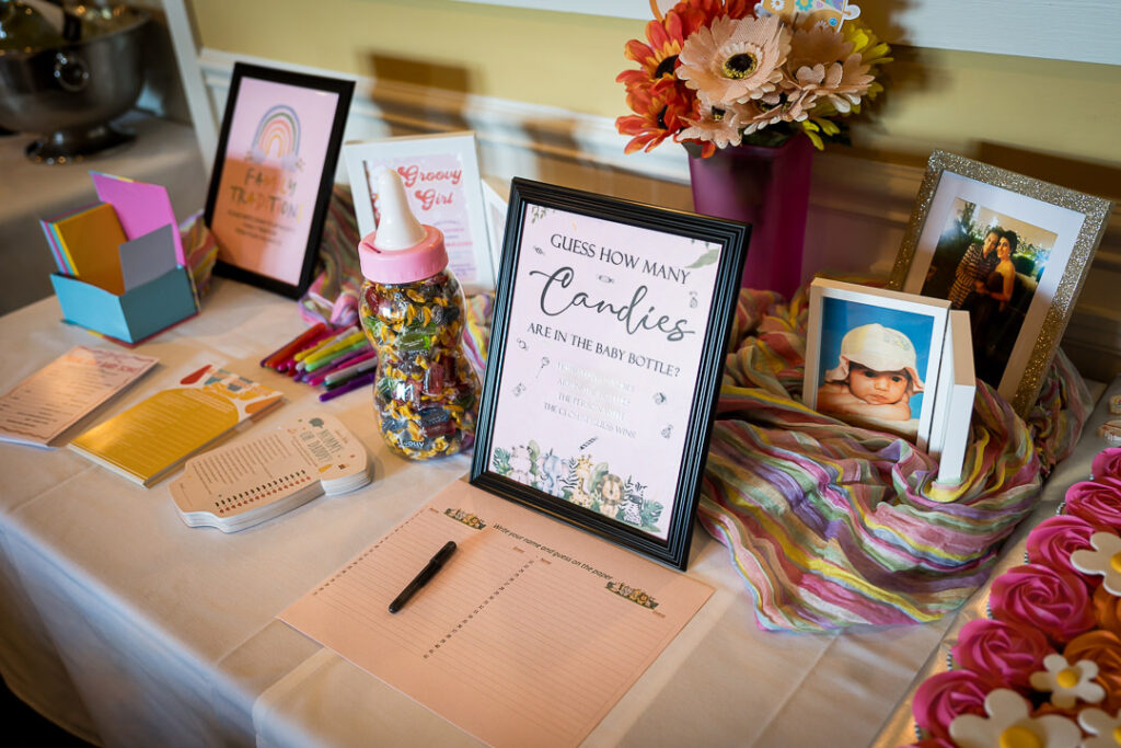 Baby shower activity table with candy guessing game and groovy decorations at Delpino NJ