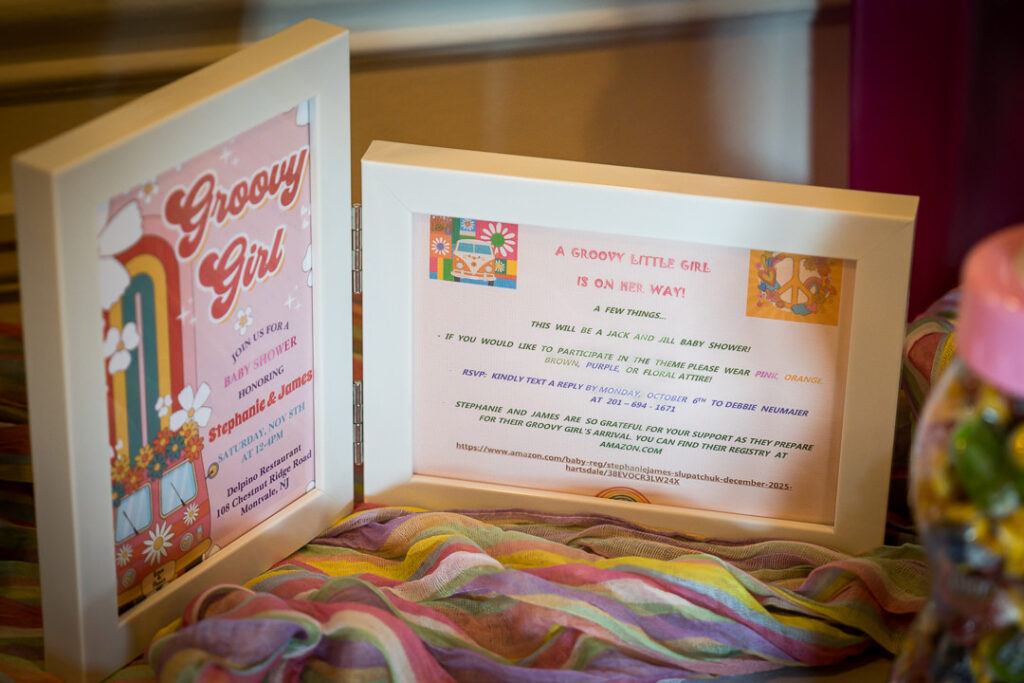 Expecting couple in pink dress and floral shirt during groovy baby shower at Delpino