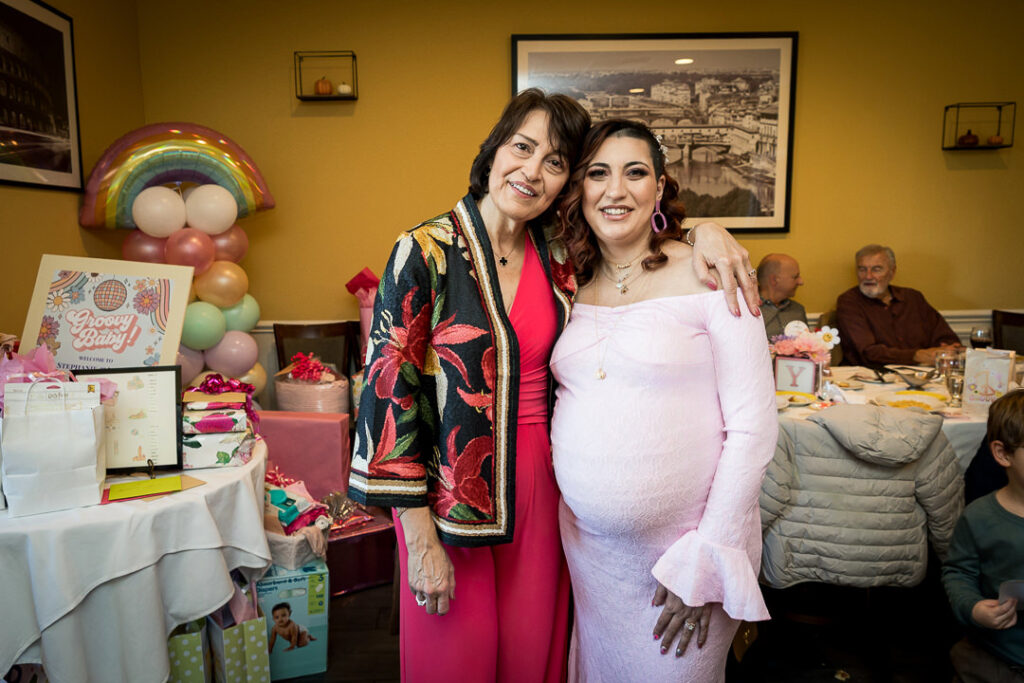 Baby shower guest wearing floral embroidered jacket at groovy themed celebration Delpino Restaurant