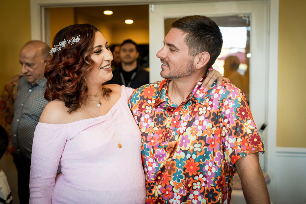 Four friends wearing pink and purple themed outfits at groovy baby shower Delpino Restaurant