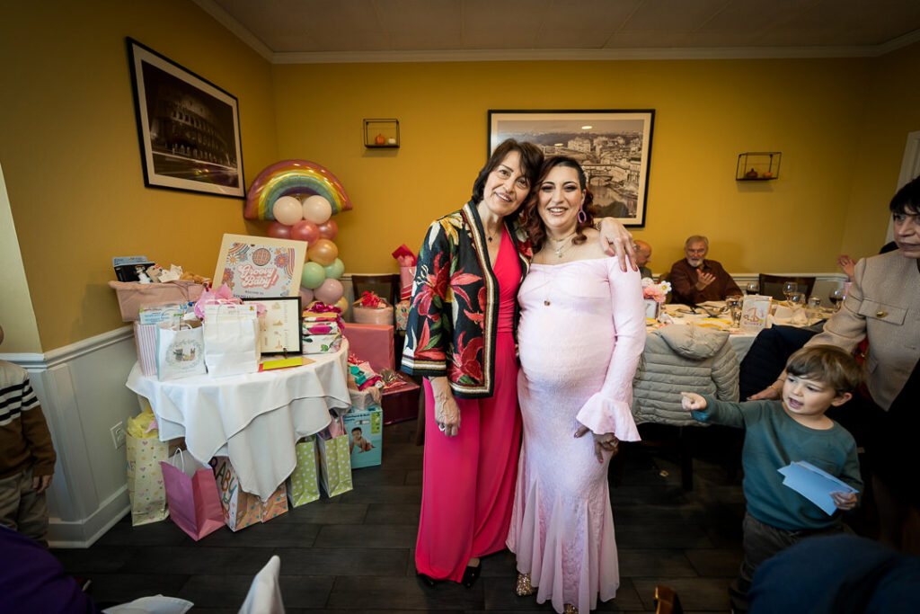 Wide view of groovy baby shower showing gift table and rainbow balloons at Delpino Restaurant