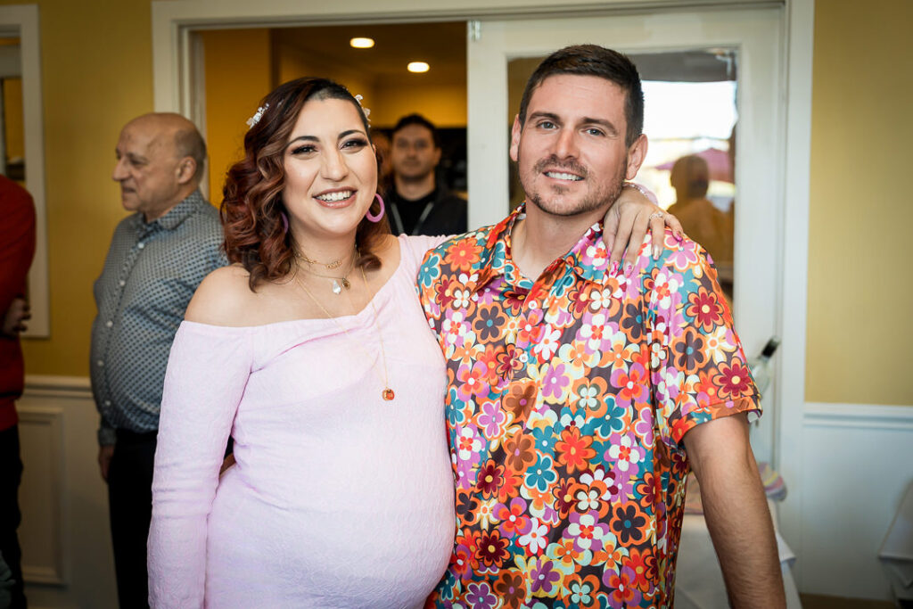 Sweet moment between expectant parents during groovy baby shower celebration at Delpino New Jersey