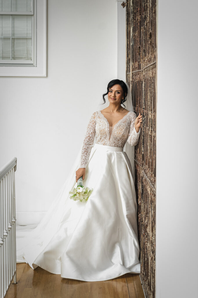 Full length bridal portrait showcasing wedding gown and veil on staircase James Ward Mansion by Alex Kaplan Photography