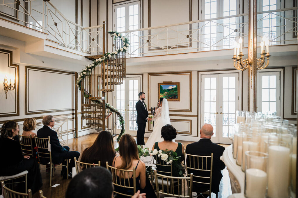 Intimate wedding ceremony at James Ward Mansion with spiral staircase in background photographed by Alex Kaplan