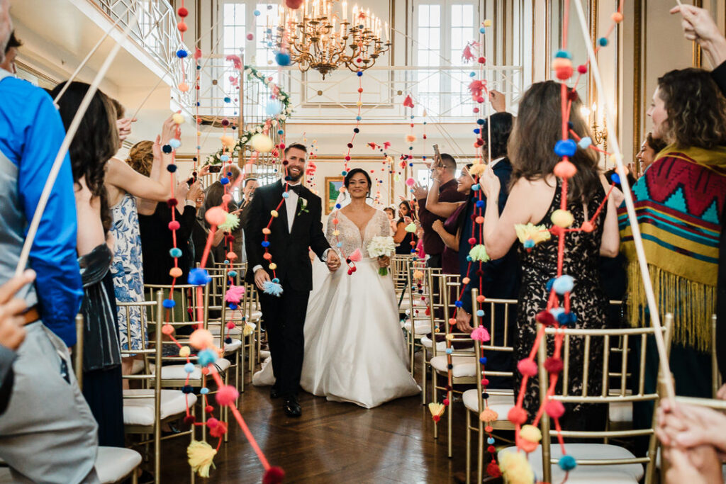 Unique colorful pom-pom garland ceremony exit at James Ward Mansion wedding in Westfield by Alex Kaplan Photography