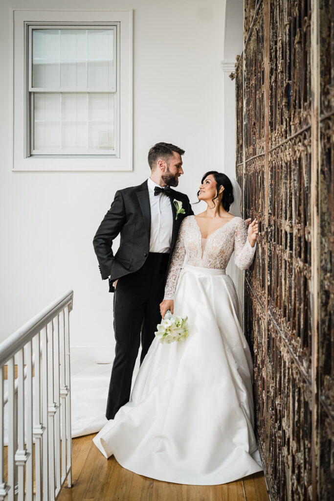 Romantic wedding couple portrait on mansion staircase with dramatic architecture by Alex Kaplan Photography