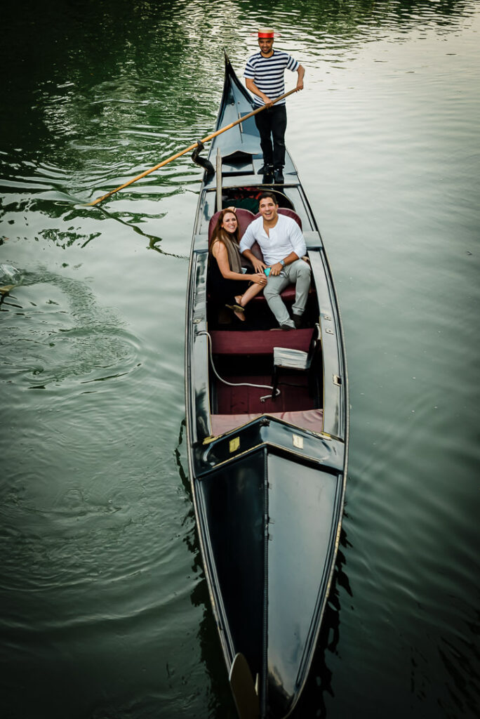 Overhead view of newly engaged couple in Venetian gondola with gondolier at Central Park Loeb Boathouse