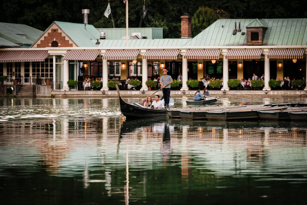 Romantic gondola proposal at Loeb Boathouse Central Park with couple enjoying champagne on the water while gondolier navigates