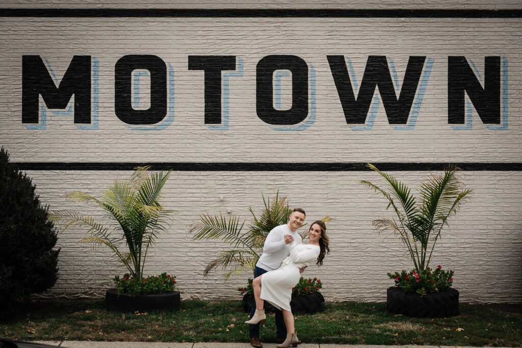 Engagement photography at famous MOTOWN mural wall in downtown Morristown with couple celebrating their engagement