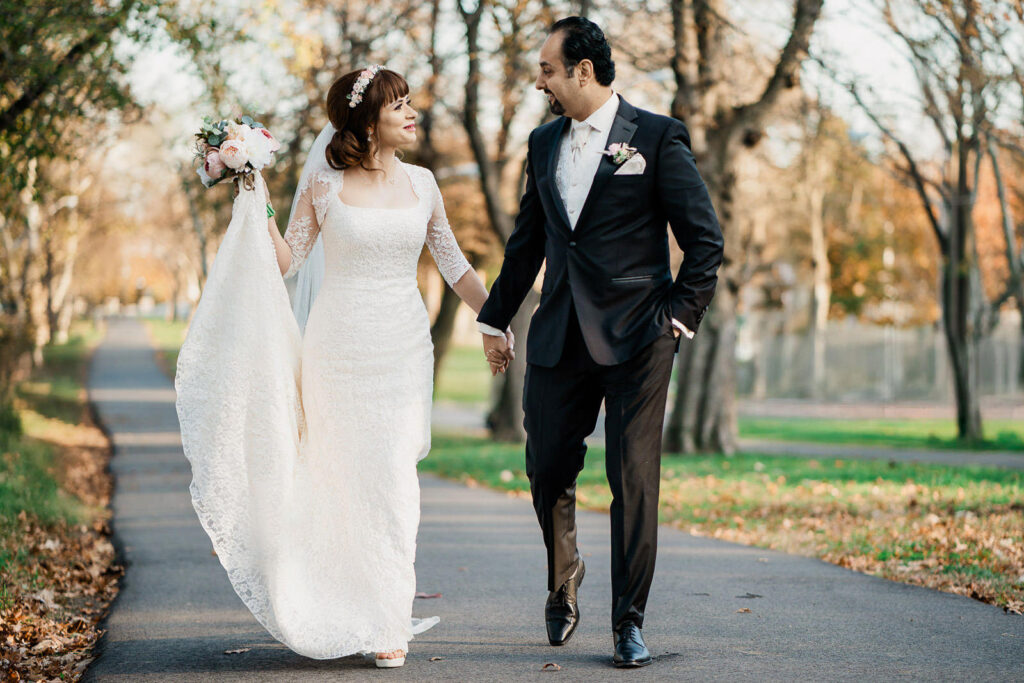 North Jersey wedding photographer Alex Kaplan captures couple walking in natural light with fall foliage
