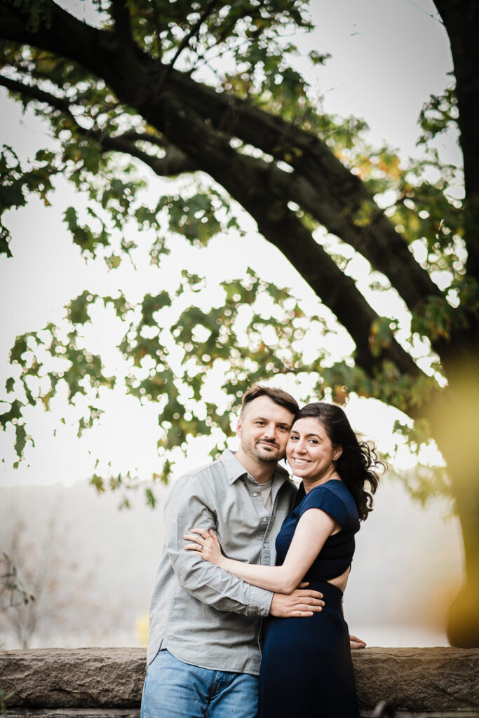 Engagement photo of couple in garden courtyard with medieval stone walls at The Cloisters