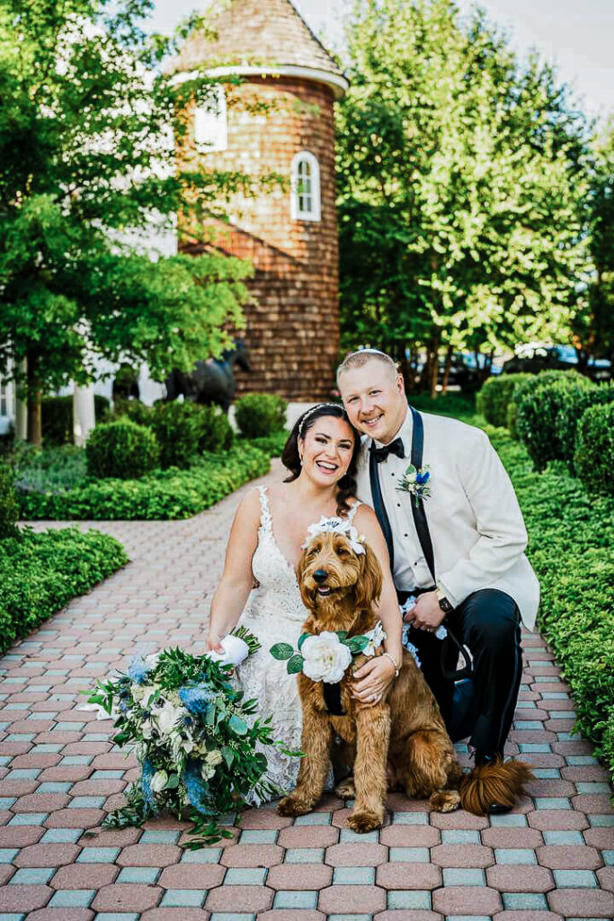 Bride and groom posing with their dog during outdoor wedding at New Jersey venue by Alex Kaplan Photography
