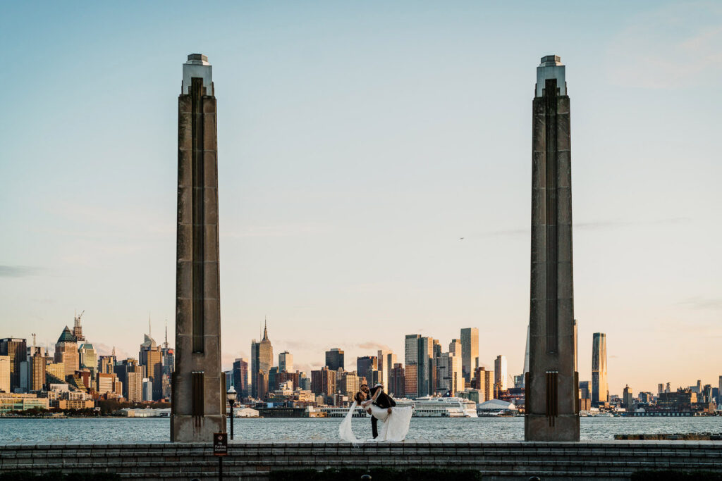 Wide angle wedding dip photo with Hudson River and NYC view by Alex Kaplan Photography