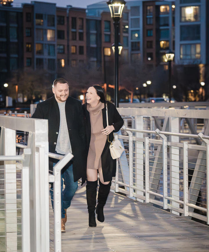 Newly engaged couple smiling and laughing together at Weehawken Pier.